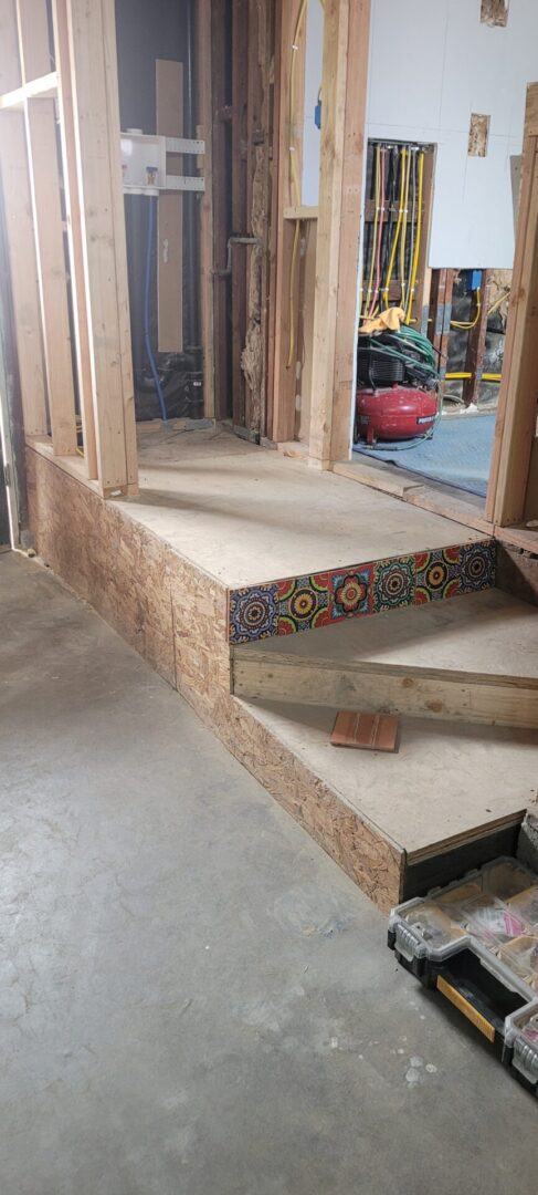 Unfinished wooden staircase with colorful tile