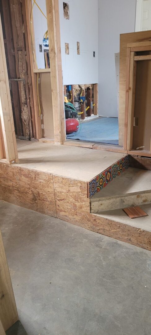 Partially renovated room with exposed framing