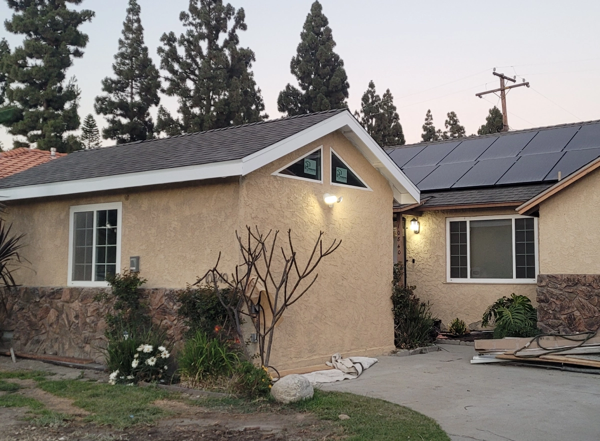 Single-story house surrounded by tall trees