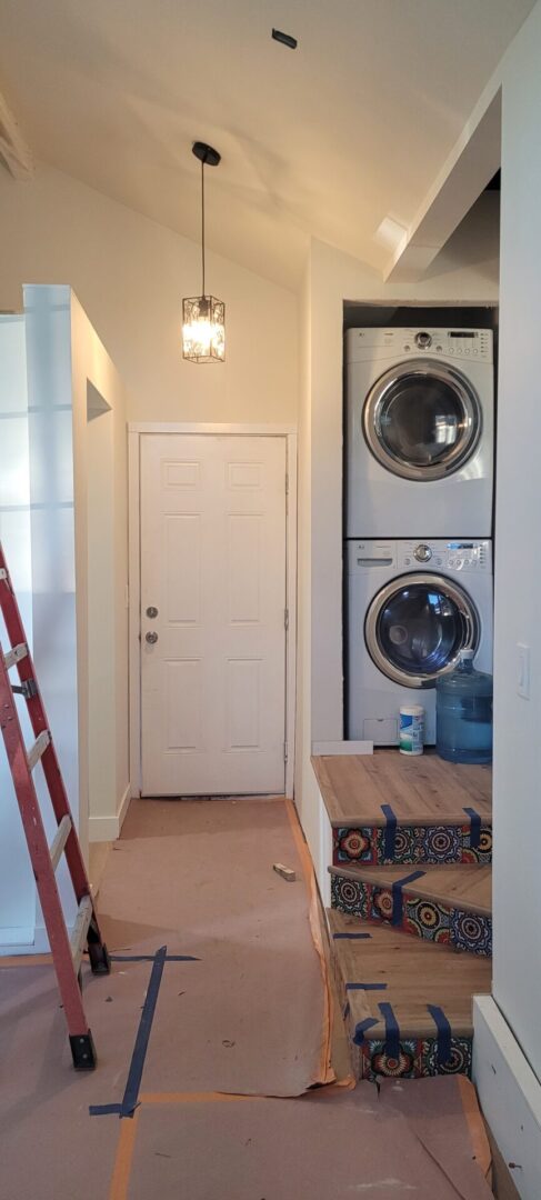 Stacked washer dryer next to door