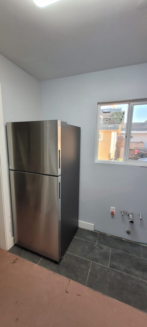 Empty kitchen corner with fridge
