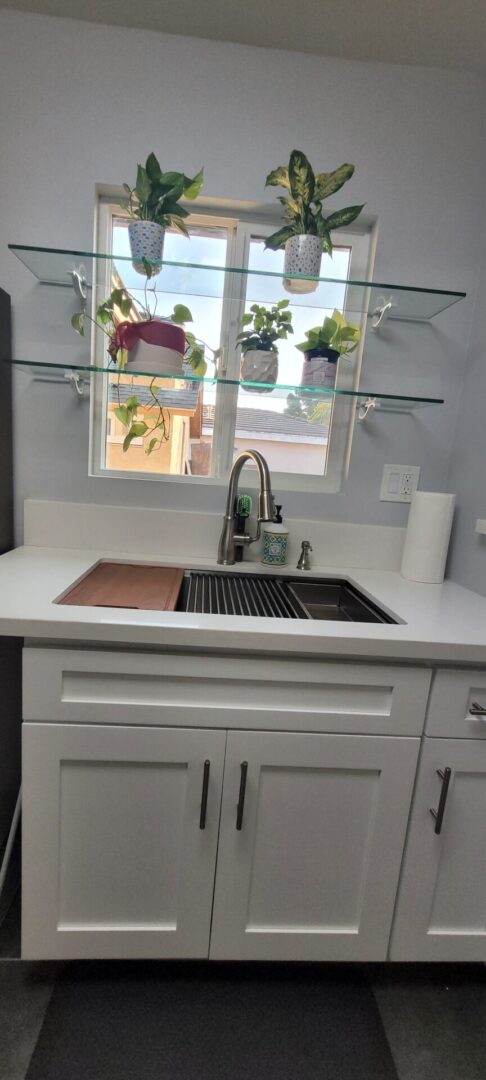 Modern kitchen sink with glass shelves