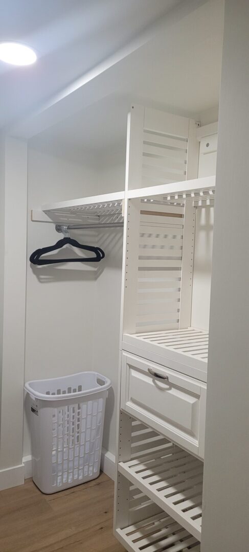 Walk-in closet with white shelving