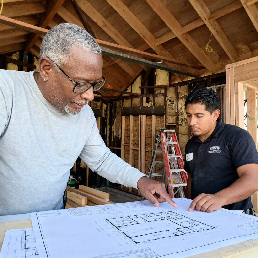 Two men examining architectural designs together